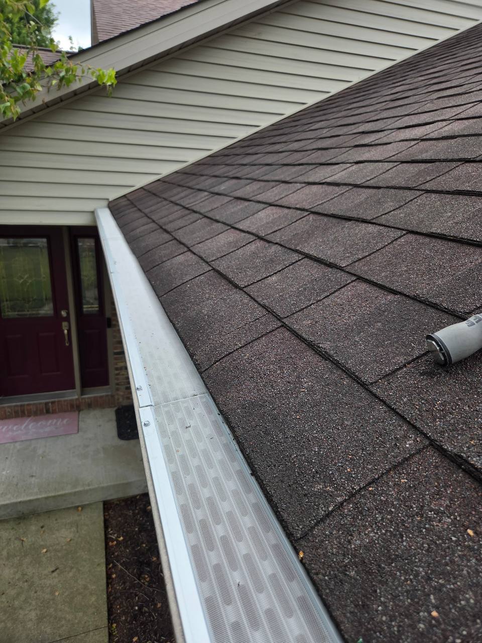 Close-up of finished white micro-mesh gutter guard installed by GutterForge