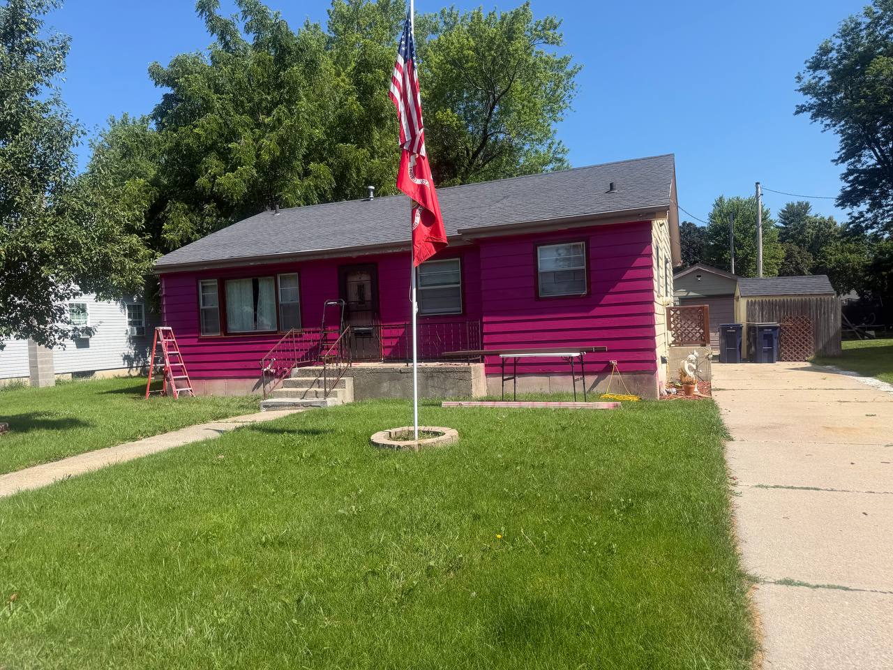 Before photo of pink peeling siding before GutterForge siding fascia and gutter work