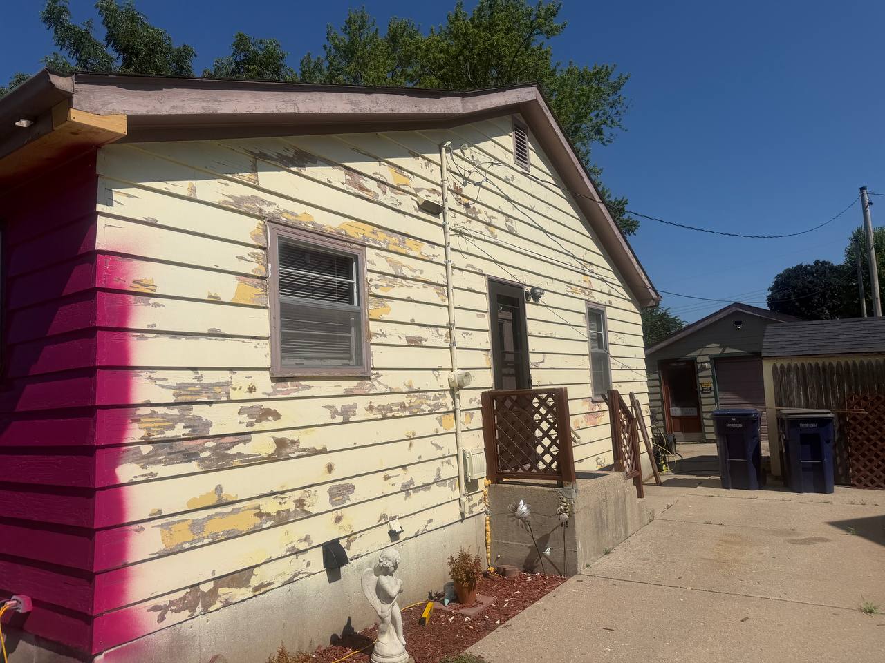 Before side photo showing peeling siding and fascia areas before exterior work
