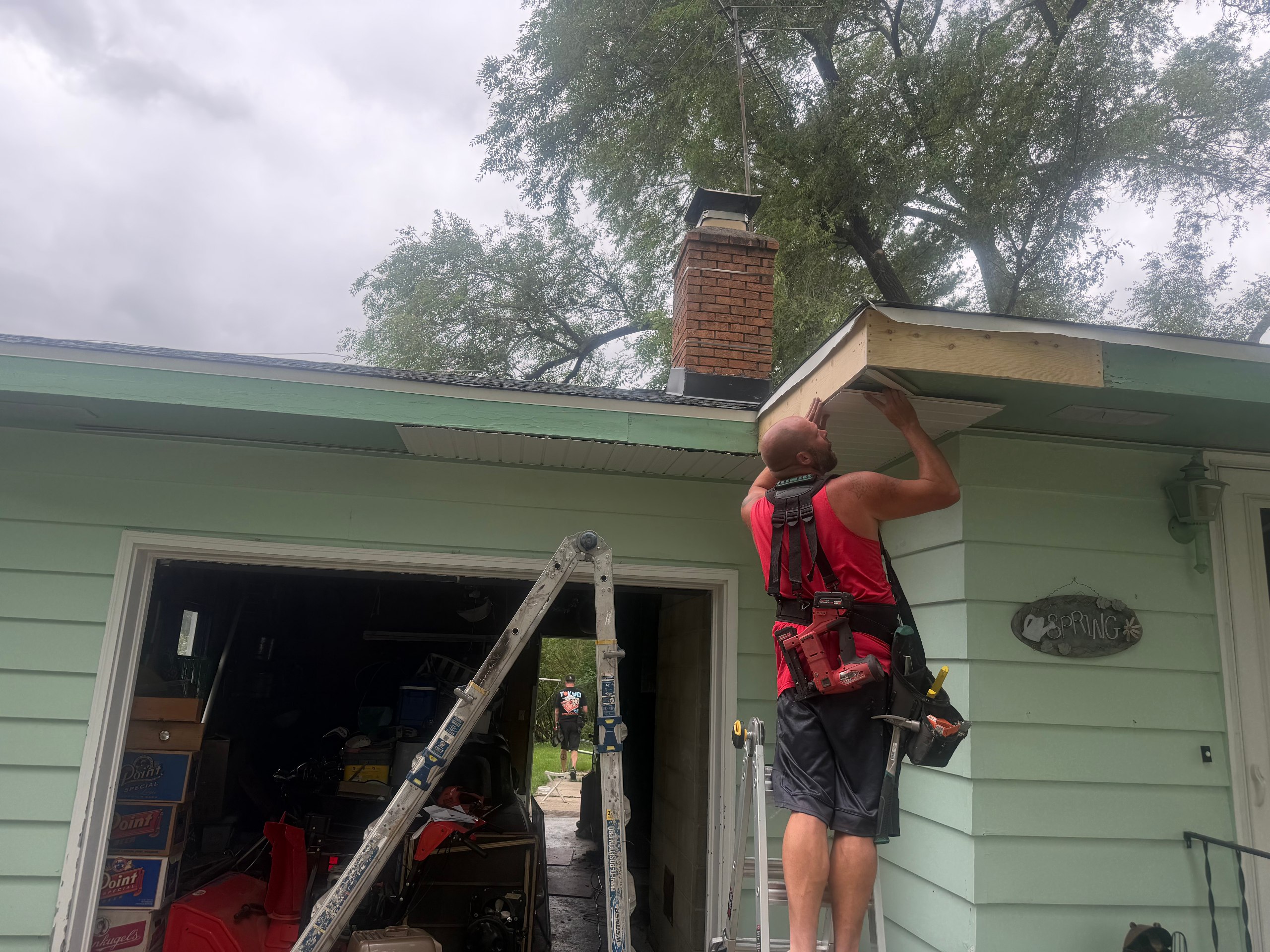 GutterForge crew installing new fascia board and soffit on a residential roofline